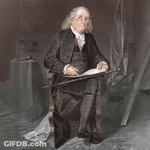 Man In Historical Costume Sitting In Office Chair GIF
