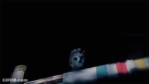 Man In Hockey Mask Holding Knife In Dark GIF