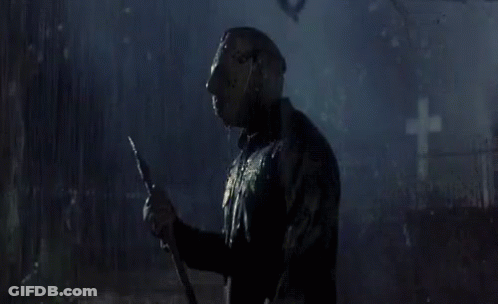 Man In Hockey Mask Holding Spear In Cemetery GIF