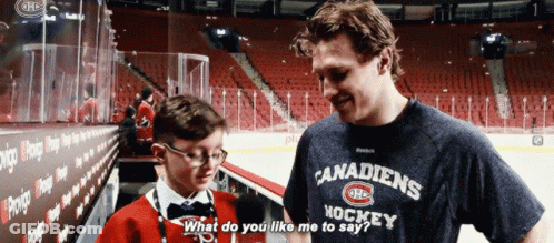 Man In Hockey Shirt Talking To Boy GIF