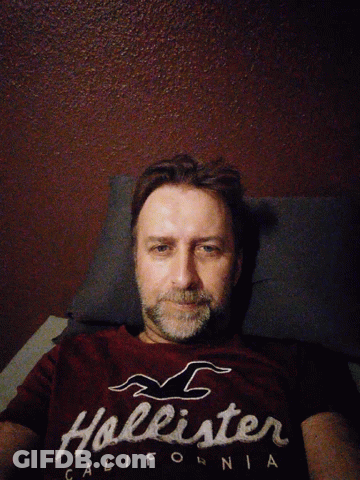 Man In Hollister T-Shirt Lying Down GIF