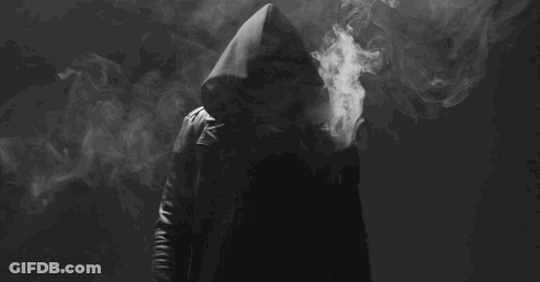 Man In Hood Smoking Electronic Cigarette In Dark GIF
