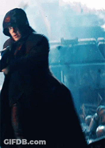 Man In Hooded Cape Holding Gun GIF