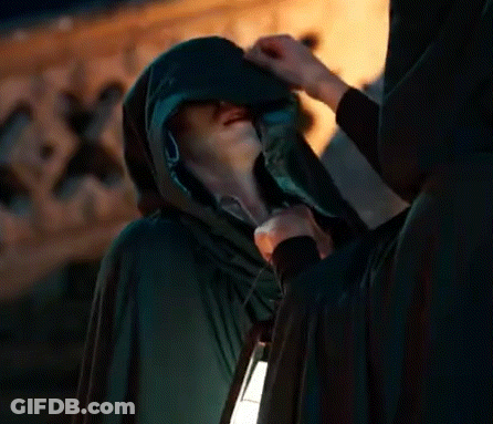 Man In Hooded Cape Holding Lantern Talking To Another Man GIF