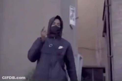 Man In Hooded Jacket And Mask Standing In Room GIF