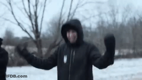 Man In Hooded Jacket And Mittens Standing In Snow GIF