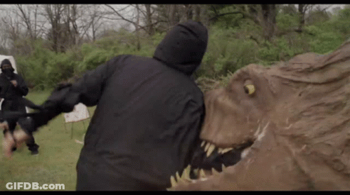 Man In Hooded Jacket Attacked By Dinosaur Statue GIF