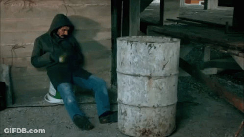 Man In Hooded Jacket By Barrel GIF