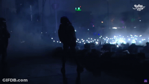 Man In Hooded Jacket Dancing In Front Of Crowd Saying Really Loud GIF