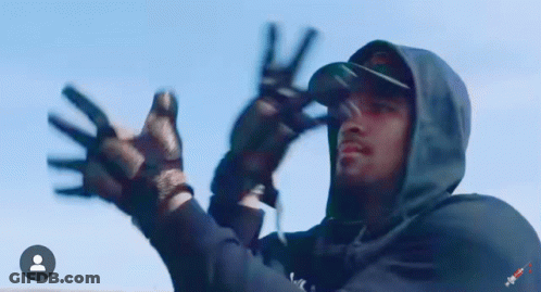 Man In Hooded Jacket Giving Peace Sign GIF