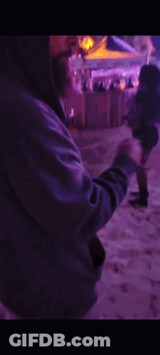 Man In Hooded Jacket In Front Of Purple Lights GIF