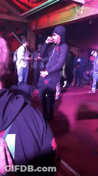 Man In Hooded Jacket Singing Into Microphone GIF