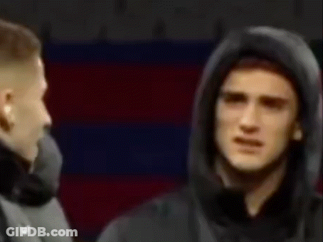Man In Hooded Jacket Standing In Front Of Man In Suit GIF