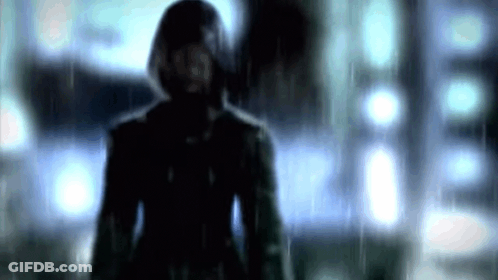 Man In Hooded Jacket Standing In Rain Blurry Photo GIF
