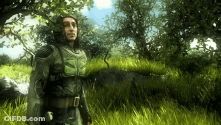 Man In Hooded Jacket Standing In Tall Grass GIF