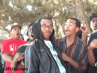 Man In Hooded Jacket Surrounded By Group GIF