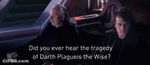 Man In Hooded Jacket Talking In Dark Room GIF