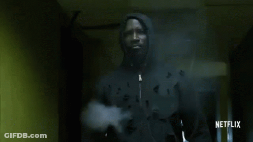 Man In Hooded Jacket Walking Hallway GIF