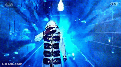 Man In Hooded Jacket Walking Through Blue Tunnel With Letters AEW GIF