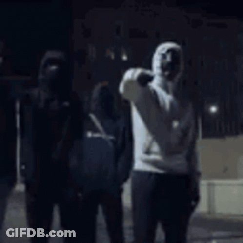 Man In Hooded Sweatshirt Standing In Dark Room GIF