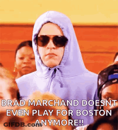 Man In Hoodie And Sunglasses Sitting In Crowd GIF