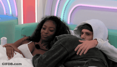 Man In Hoodie And Woman Laying On Couch GIF