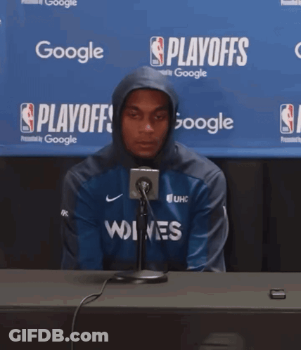 Man In Hoodie At Table With Google Banner GIF