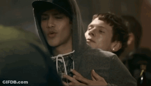 Man In Hoodie Held By Man In Plaid Shirt GIF