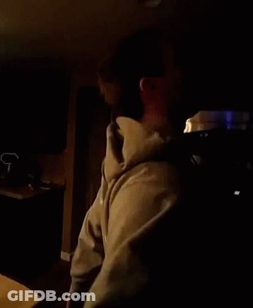 Man In Hoodie In Dark Room GIF