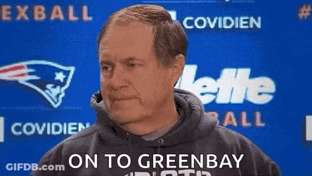 Man In Hoodie In Front Of Green Bay Packers Logo GIF