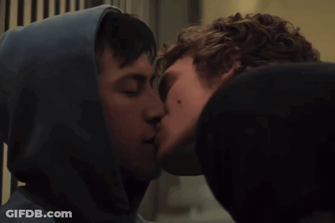 Man In Hoodie Kissing Another Man On Cheek GIF