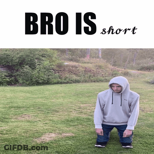 Man In Hoodie Kneeling In Grass Saying Bro Is Short GIF