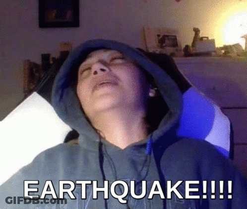 Man In Hoodie Laying Down Saying Earthquake GIF
