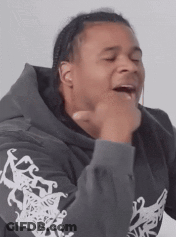 Man In Hoodie Making Funny Face With Hands On Chin GIF