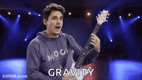 Man In Hoodie Playing Guitar Says Gravity GIF