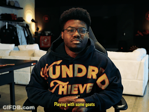 Man In Hoodie Playing With Goats GIF