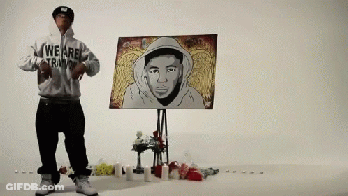 Man In Hoodie Saying We Are Trainin In Front Of Painting GIF