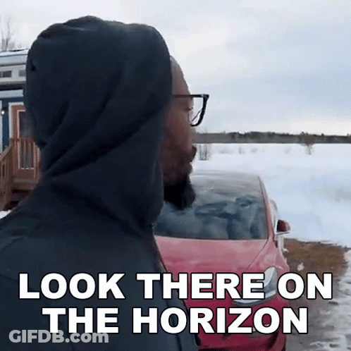 Man In Hoodie Says Look There On The Horizon GIF