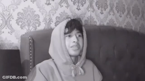 Man In Hoodie Sitting On Couch GIF