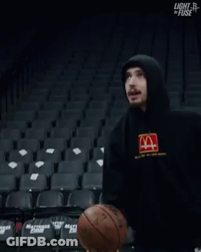 Man In Hoodie Standing In Empty Basketball Stadium GIF
