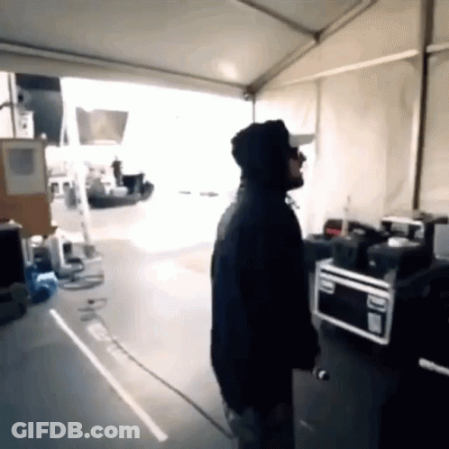 Man In Hoodie Standing Near Microwave GIF