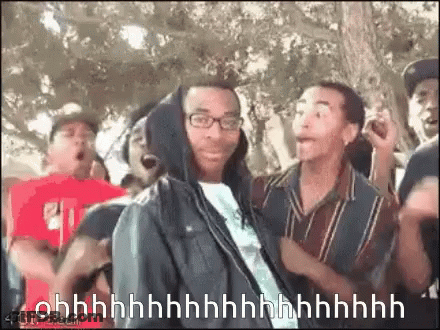 Man In Hoodie Surrounded By Crowd Saying Ohh GIF
