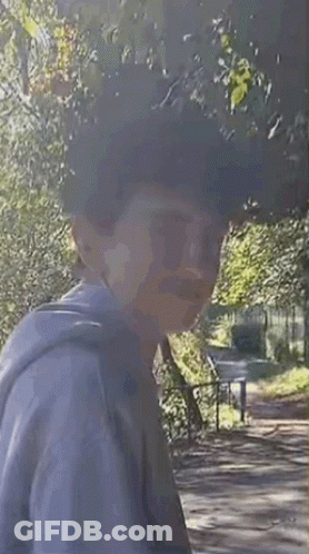 Man In Hoodie Walking In Woods GIF