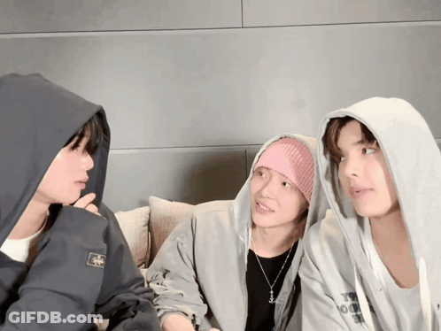 Man In Hoodie With A Talks To Two Men GIF