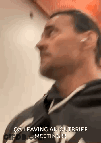 Man In Hoodie With Earbuds Leaving Meeting GIF