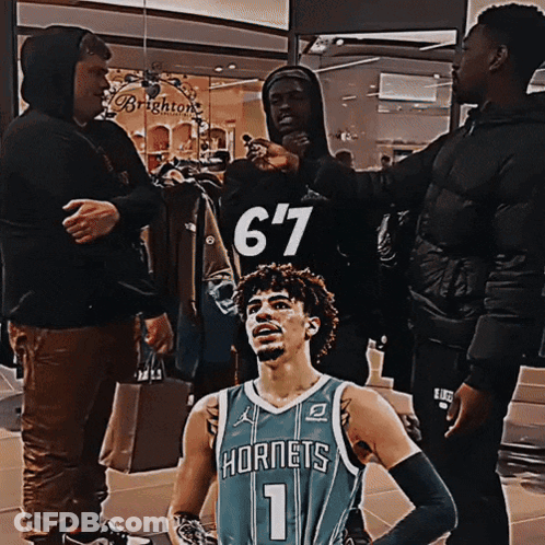 Man In Hornets Jersey With Group Of Men GIF