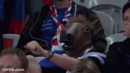 Man In Horse Mask Sitting In Stadium GIF