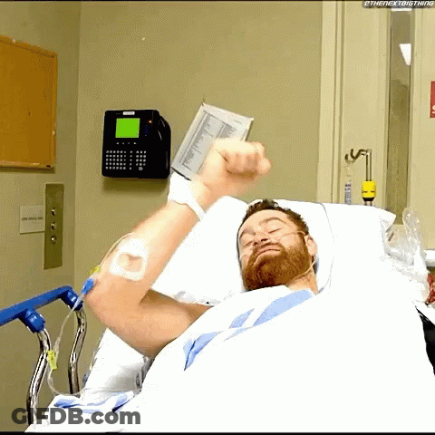 Man In Hospital Bed With Fist Up GIF