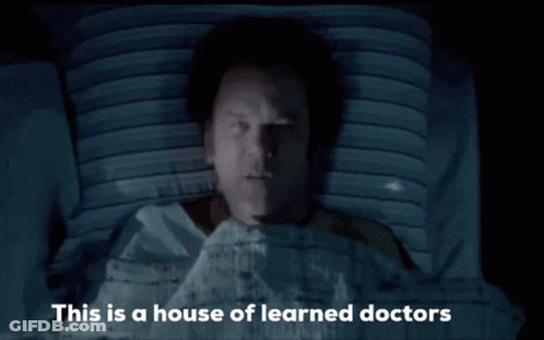 Man In Hospital Bed With Learned Doctors GIF