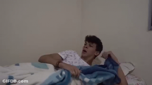 Man In Hospital Gown Screaming On Bed GIF